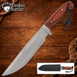 Large knife with wooden handle on wooden background