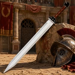 Roman sword and helmet on sandy arena floor