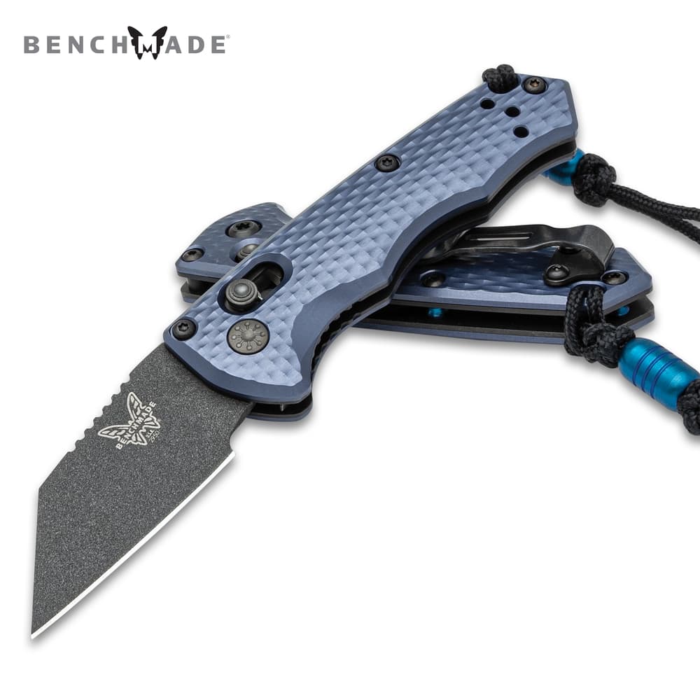 Benchmade Partial Immunity Automatic Knife with 1 9/10” CPM-M4 stainless steel, Wharncliffe blade with a cobalt black Cerakote finish shown open with black lanyard. image number 0