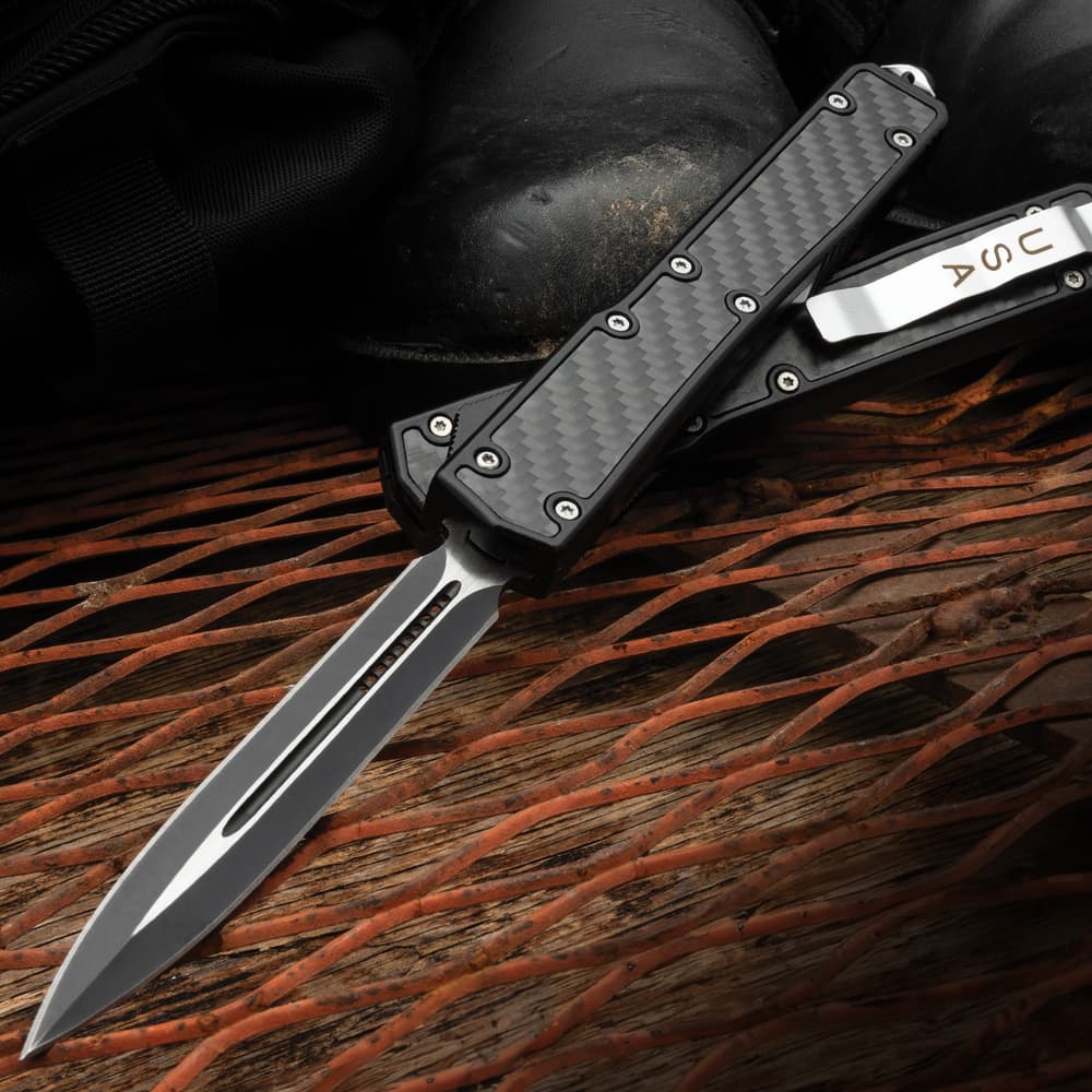 Black tactical automatic knife, shown both open and closed, with two tone black and silver blade and black handle. image number 0