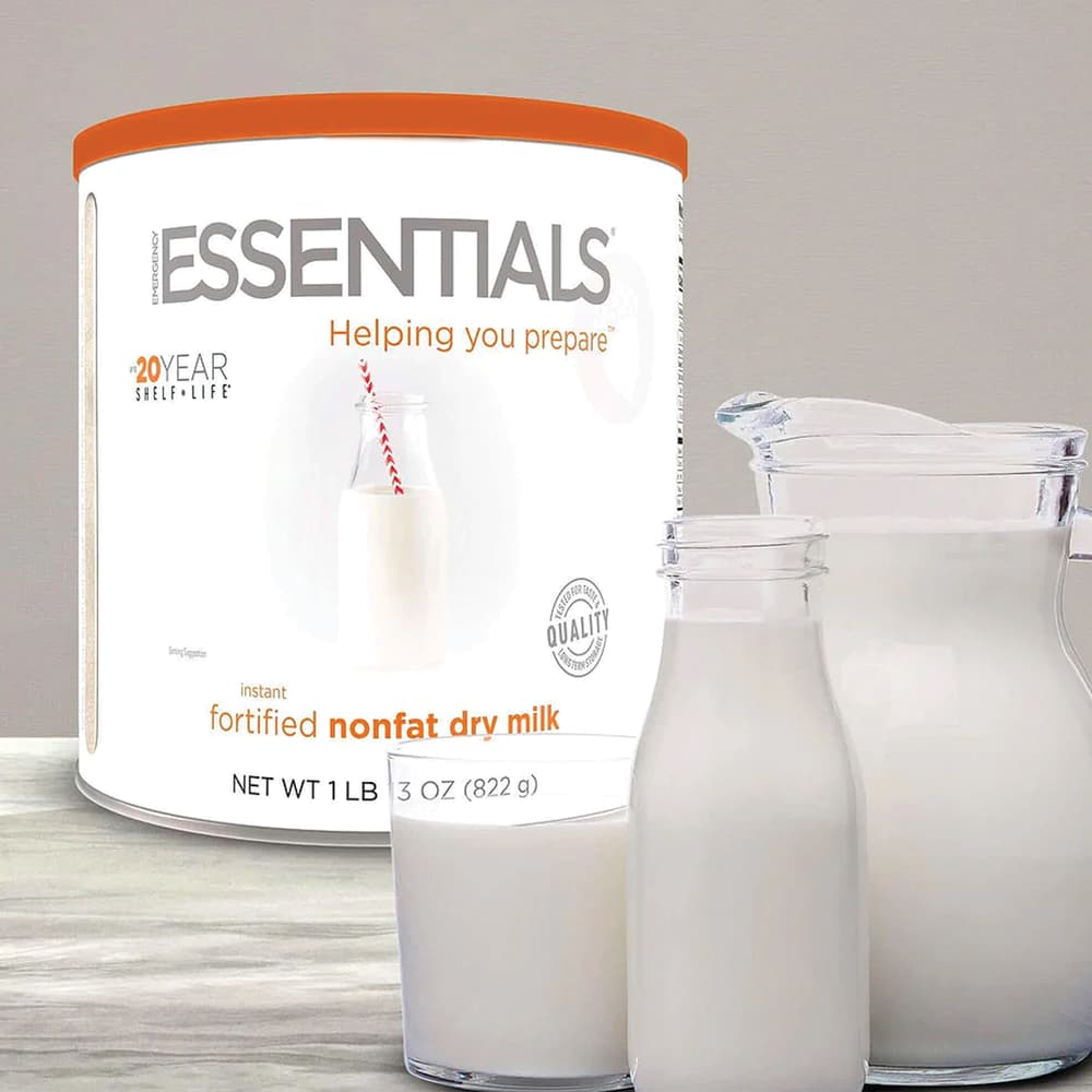 Emergency Essentials Instant Dry Milk shown in its container and reconstituted in glass containers image number 0