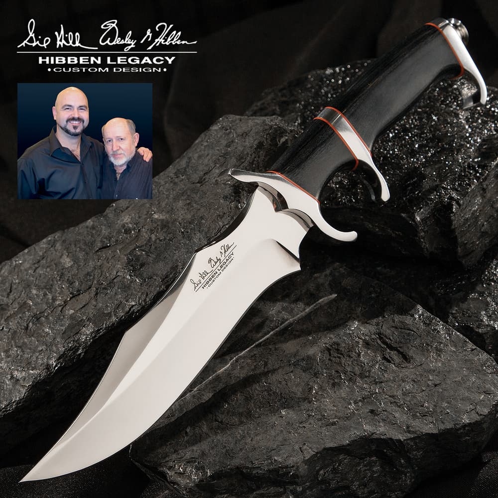 Legacy III fighter knife with black, silver, and red accents on a background of black rocks. image number 0