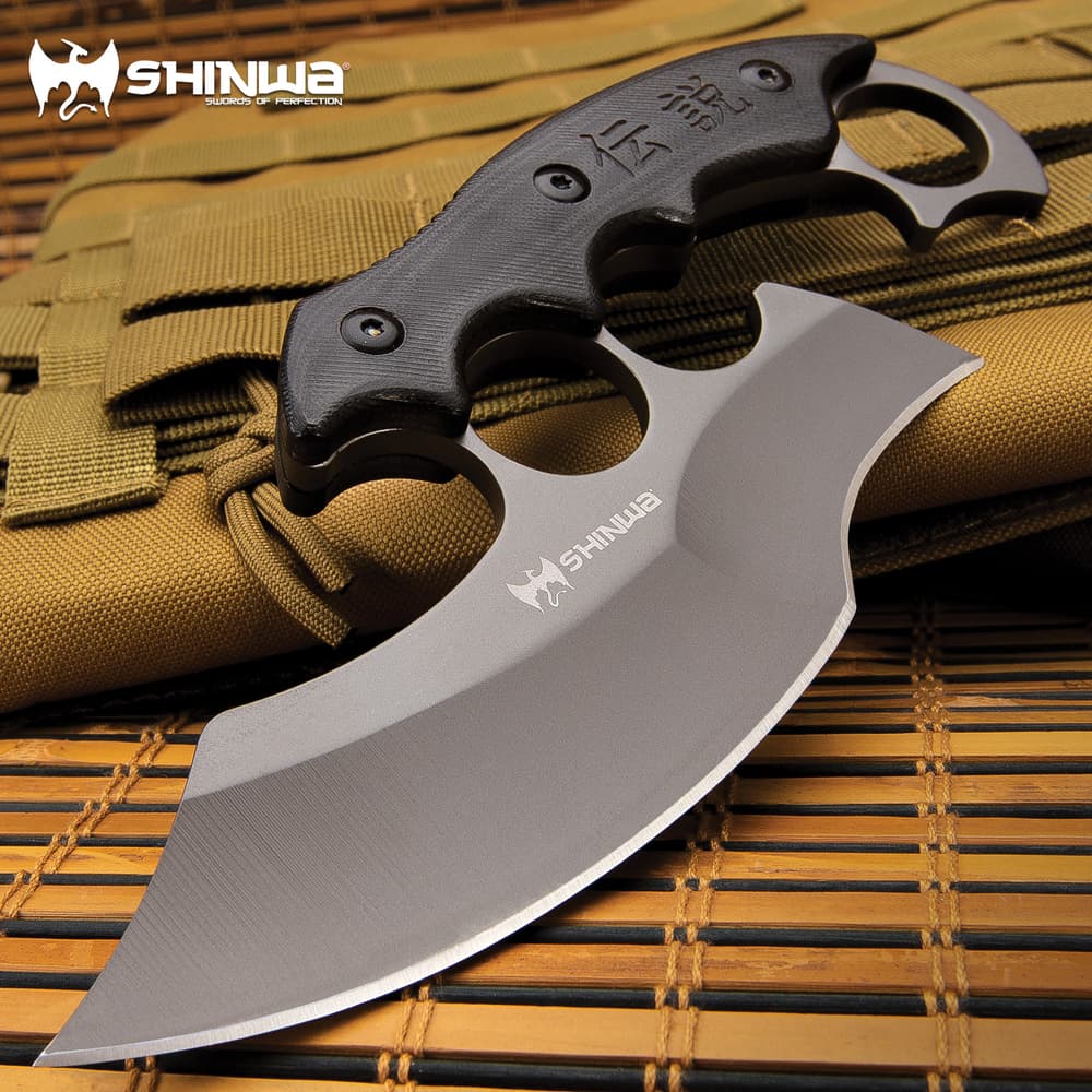 A uniquely designed fixed blade, which combines elements from the traditional karambit and ulu knife, along with a modified knuckle guard image number 0