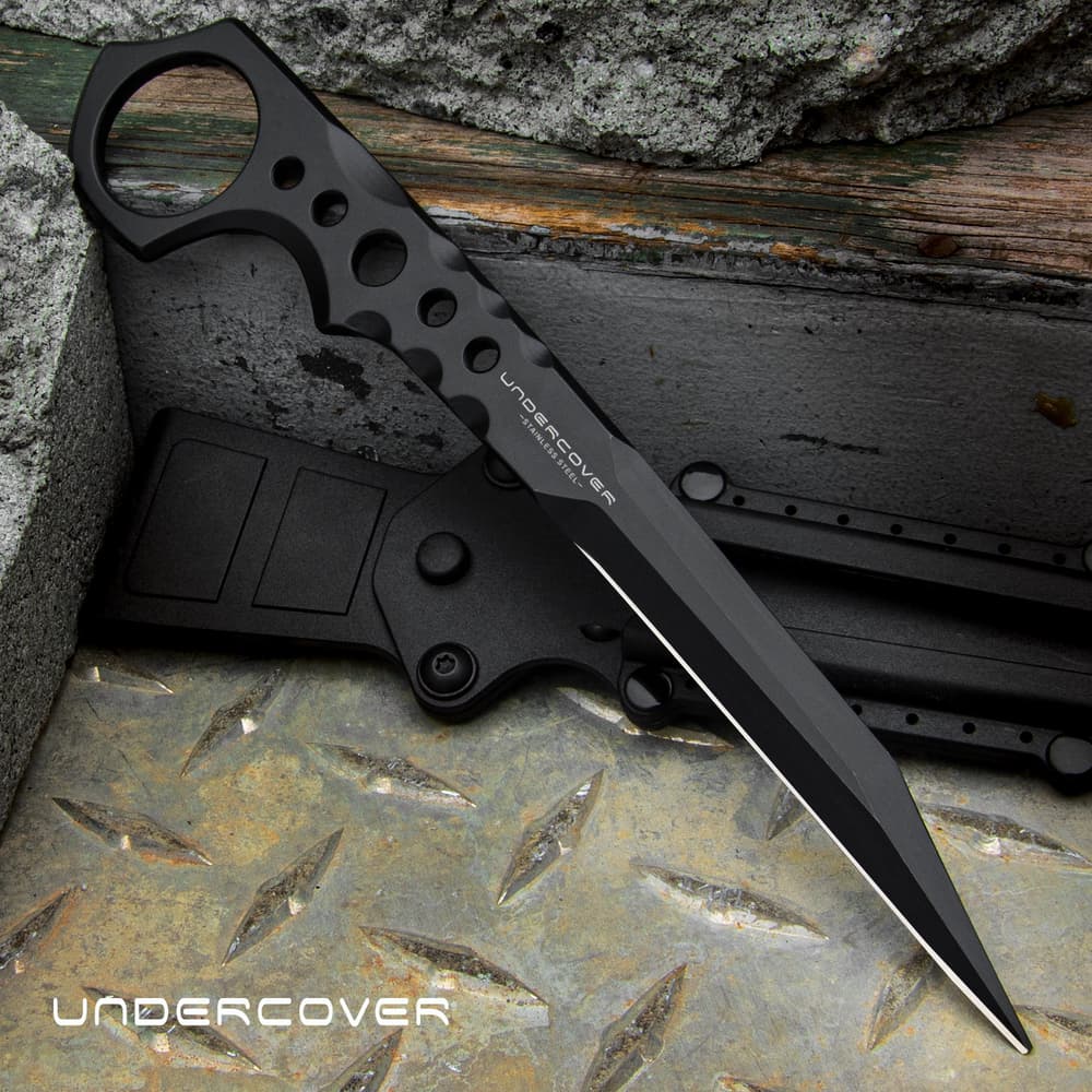 Slim black 7 1/4" stinger knife with an open ring pommel and the text "UNDERCOVER" displayed in the center of the knife and in the bottom left corner. image number 0