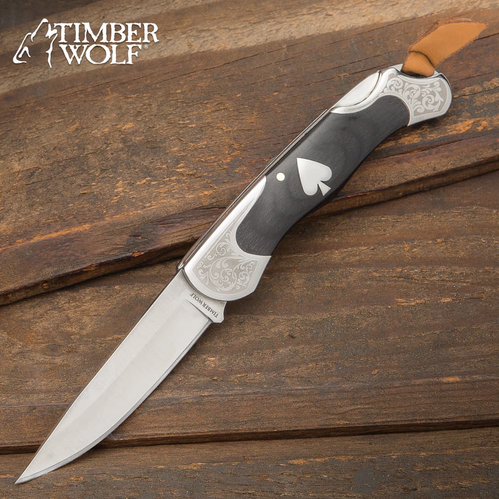 The Timber Wolf Gambler Lockback Pocket Knife has an Old West gambler feel with its wood and polished steel construction, accented by an ace medallion image number 0