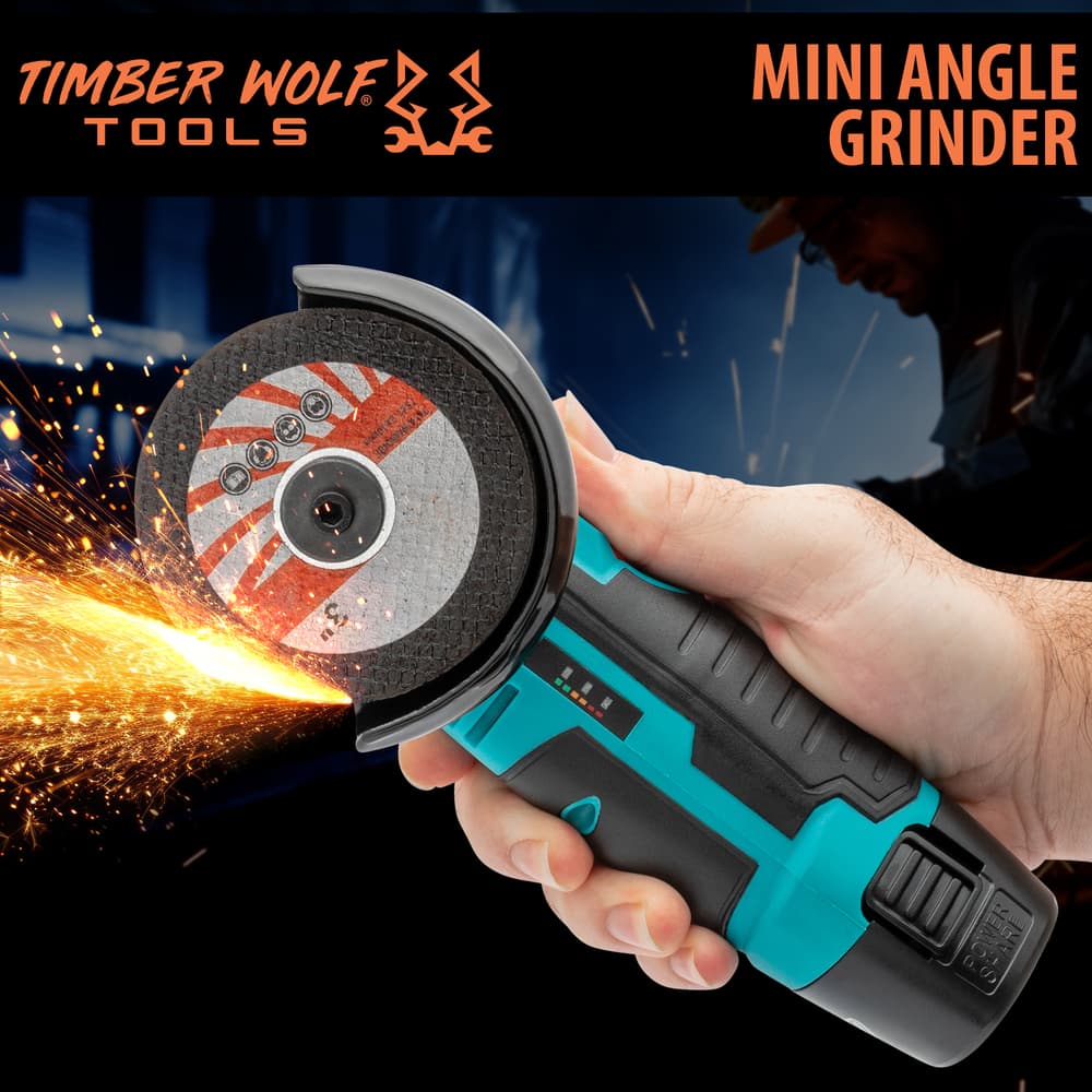 The Timber Wolf Tools Mini Angle Grinder is shown in hand with sparks flying off the grinder. image number 0