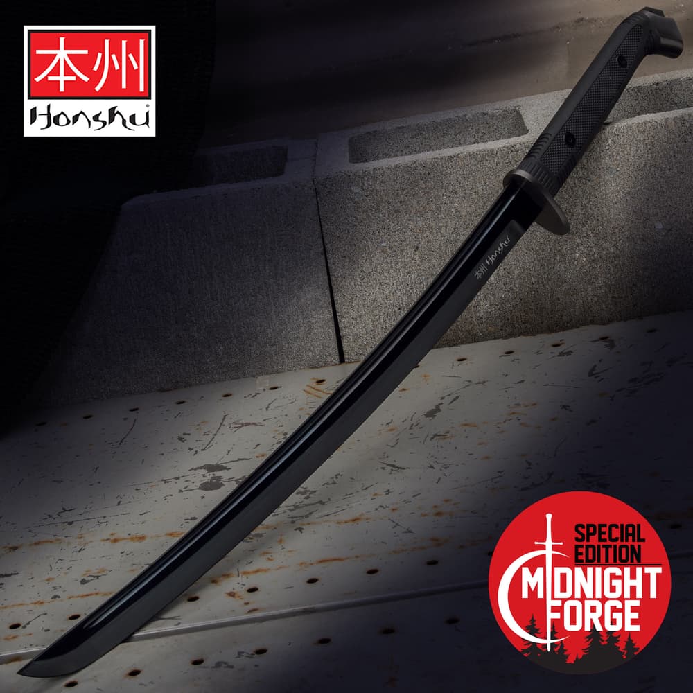 Special edition Black Honshu Boshin wakizashi 1060 high carbon steel blade with black TPR handle on to of cement blocks image number 0
