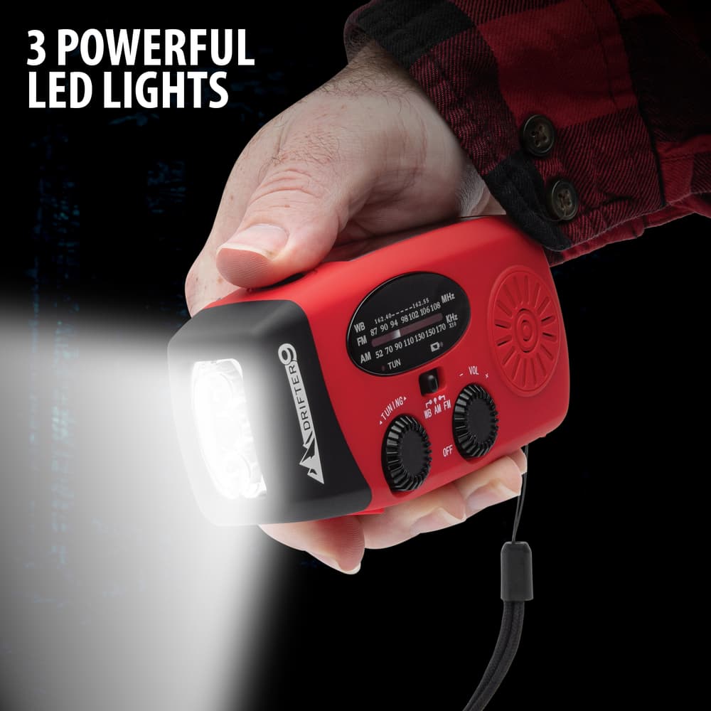 Full image of Portable Emergency Hand Crank Solar Radio held in hand with LED light turned on. image number 1