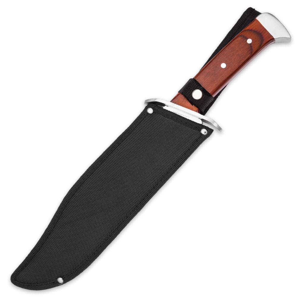 Wood handled bowie knife with mirror polished silver accents enclosed in a black nylon sheath with button closure. image number 1