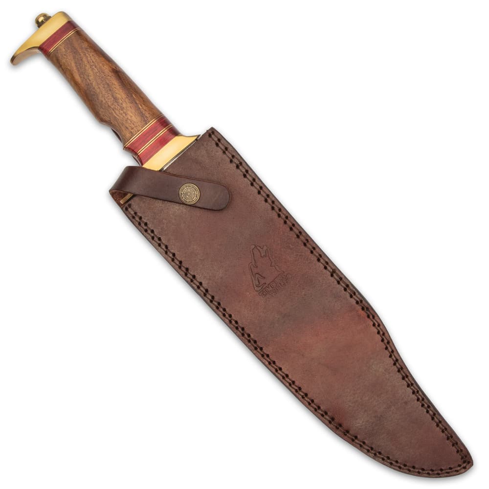 The 17” bowie can be stored and carried in its genuine, premium leather belt sheath, which has a snap strap closure image number 1