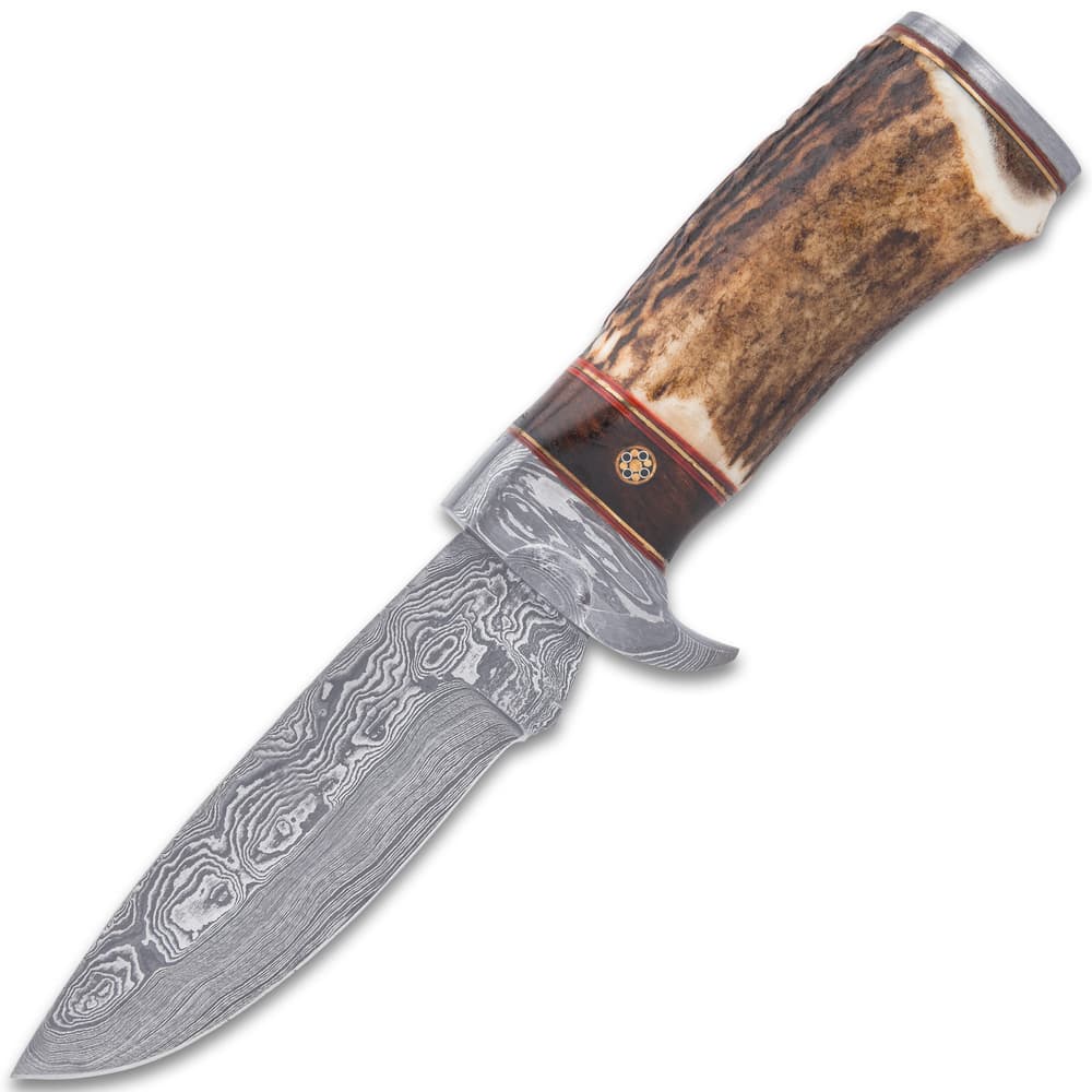 The knife has a keenly sharp, 4 1/2”” Damascus steel blade with fileworking and it extends from a Damascus steel half-guard image number 1