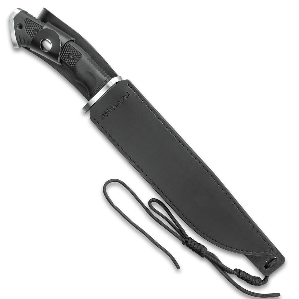 The bowie knife is shown secured into its leather belt sheath with lanyard cord. image number 1