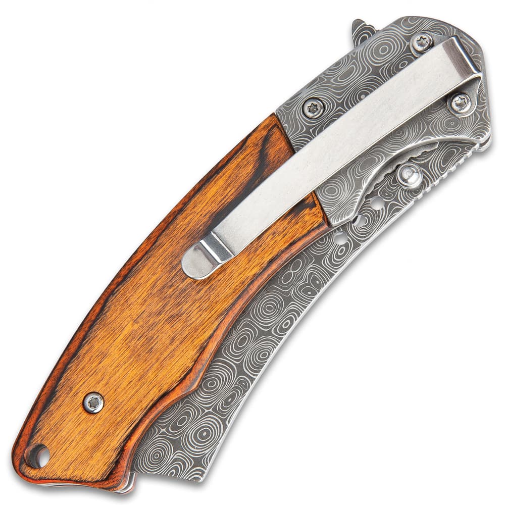 On the back of the wooden handle scales is a stainless steel pocket clip for easy carrying. image number 1