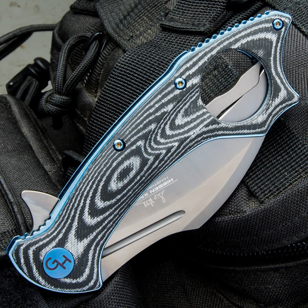 The karambit is 4 3/4”, when closed, 7 1/2” in overall length, and has a blue metallic pocket clip with the Hibben Knives logo image number 1
