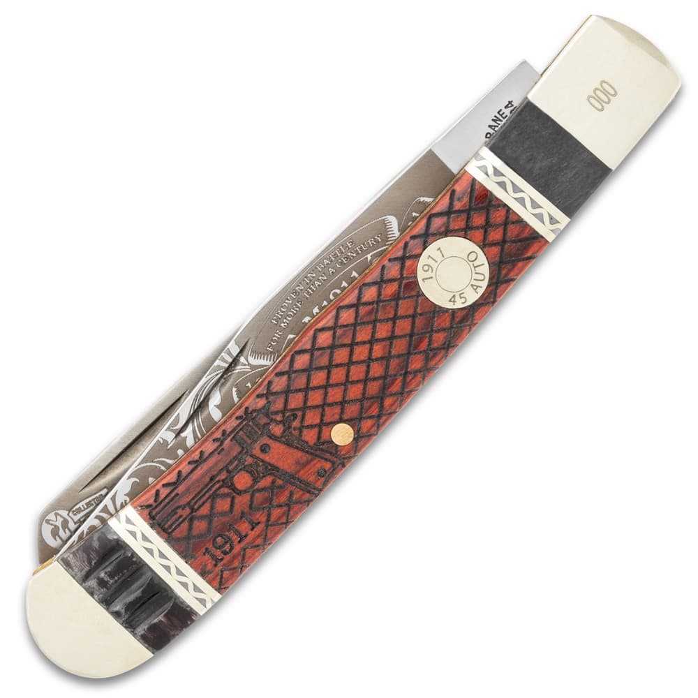 The trapper knife has a wooden handle with M1911 Pistol themed artwork. image number 1