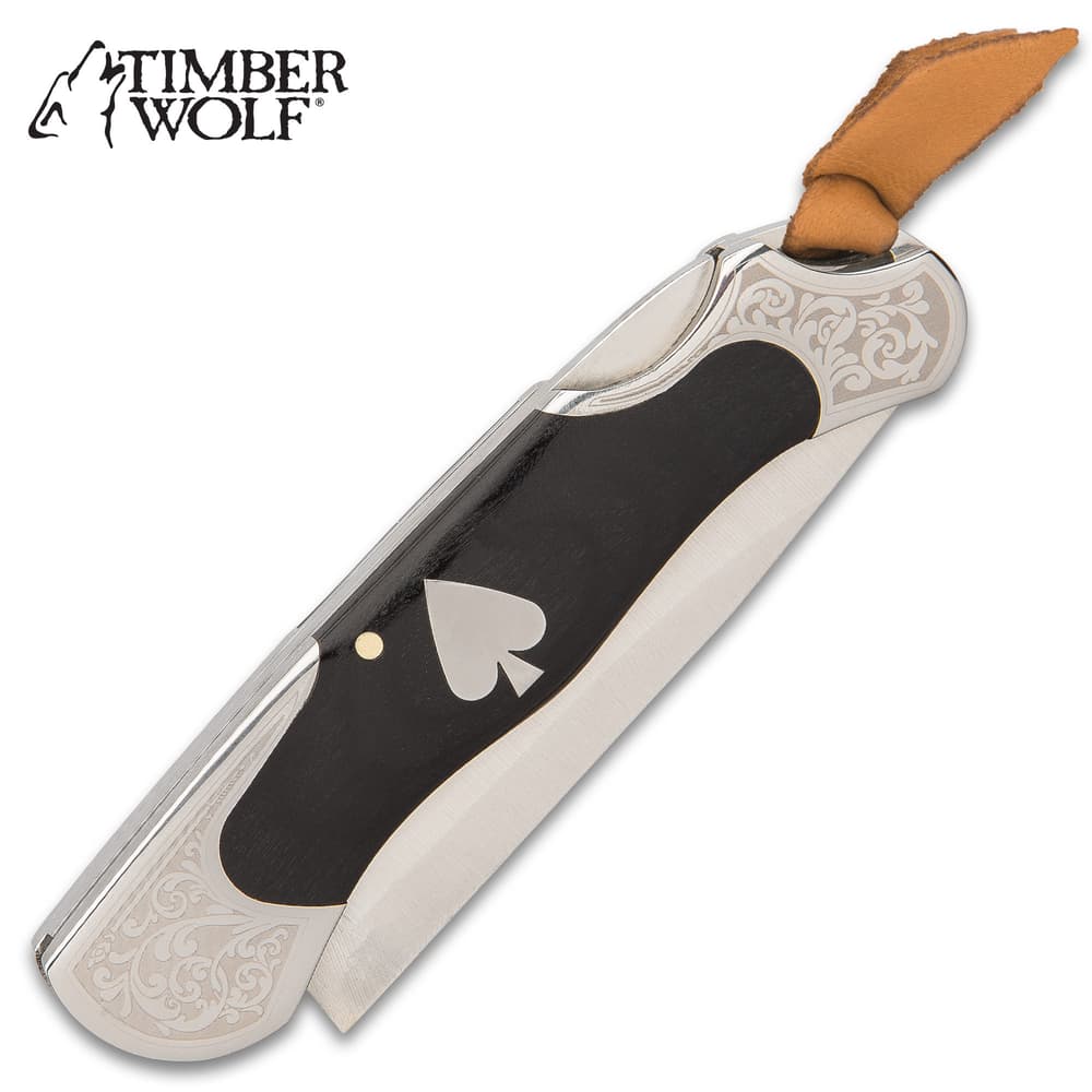 The handle has black wooden inserts, which feature the silver ace medallion, and the highly polished steel bolsters have decorative etching image number 1