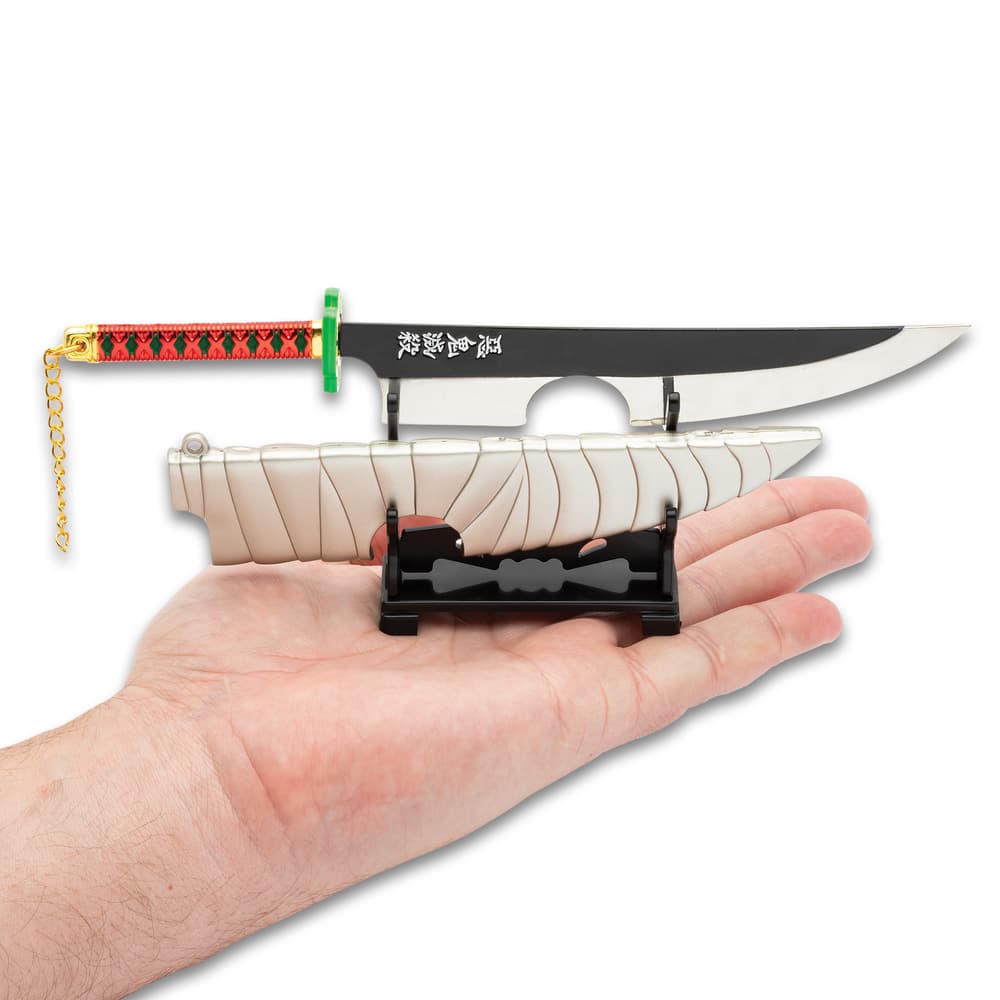 Full image of the Collectible Anime Sword with the stand held in hand. image number 1
