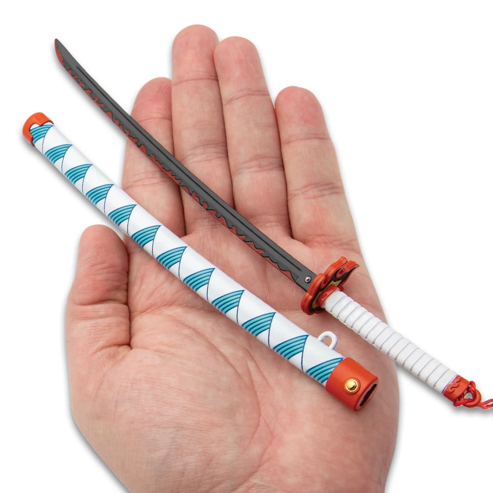 Full image of the Mini Collectible Sword held in hand. image number 1