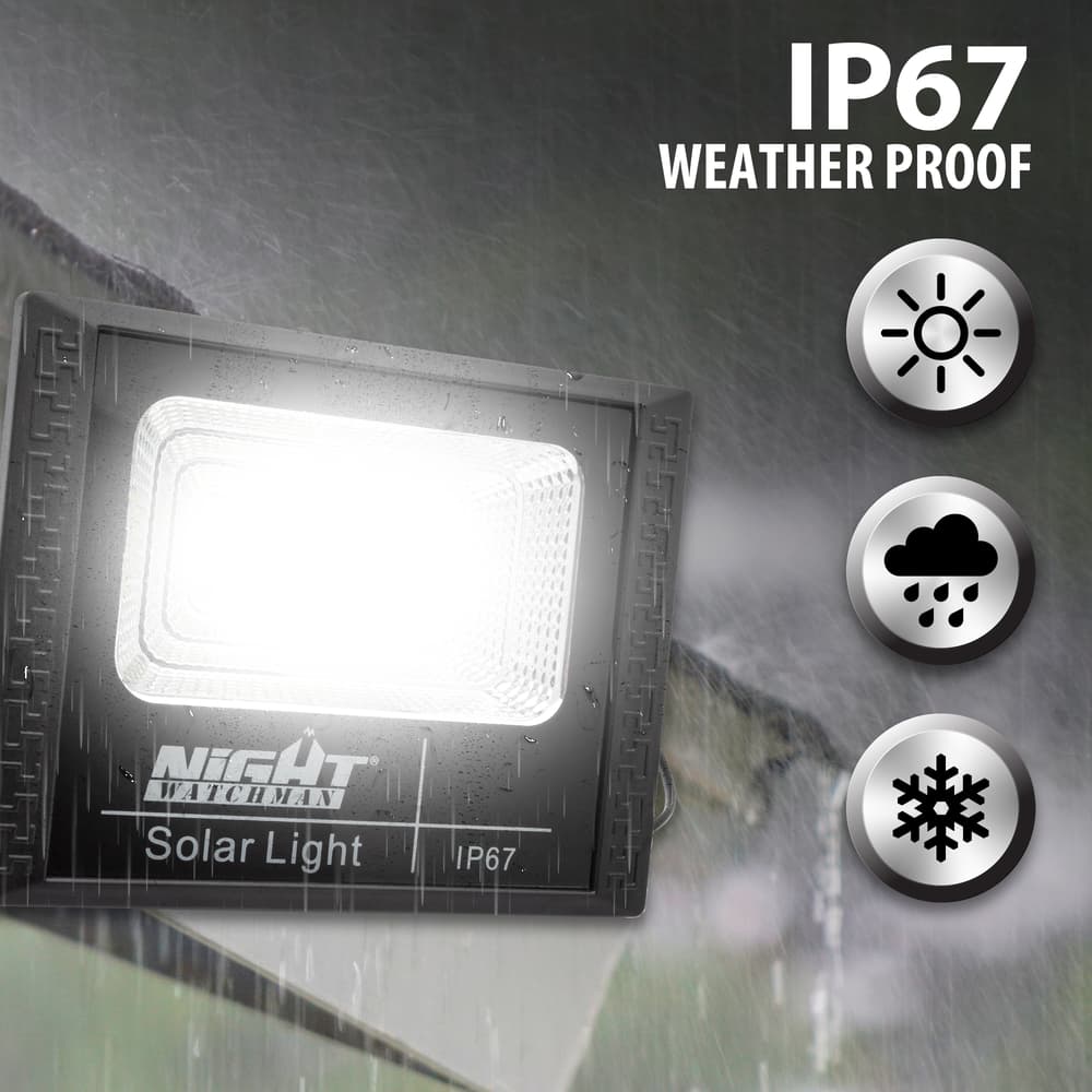 Full image of the Outdoor Solar Light 580 Lumens out in the rain displaying that it is IP67 weather proof. image number 1