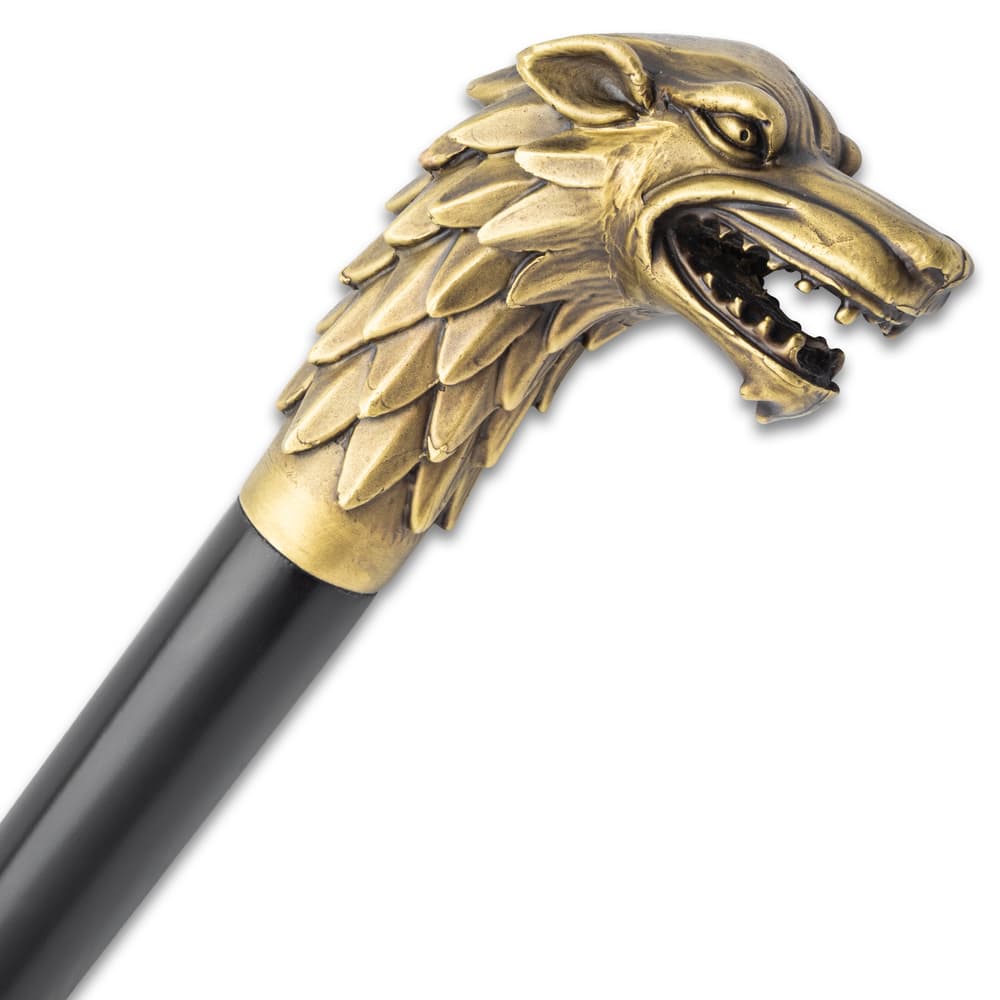 The handle of the cane is a wolf head sculpted in brass image number 1