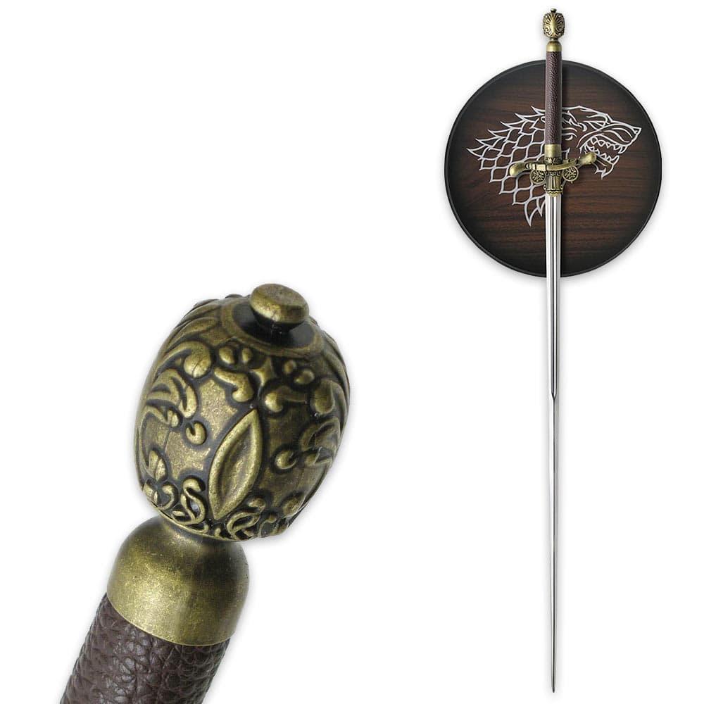 The sword is shown hanging on a wall plaque with Direwolf sigil and with zoomed view of the sword’s ornate pommel. image number 1