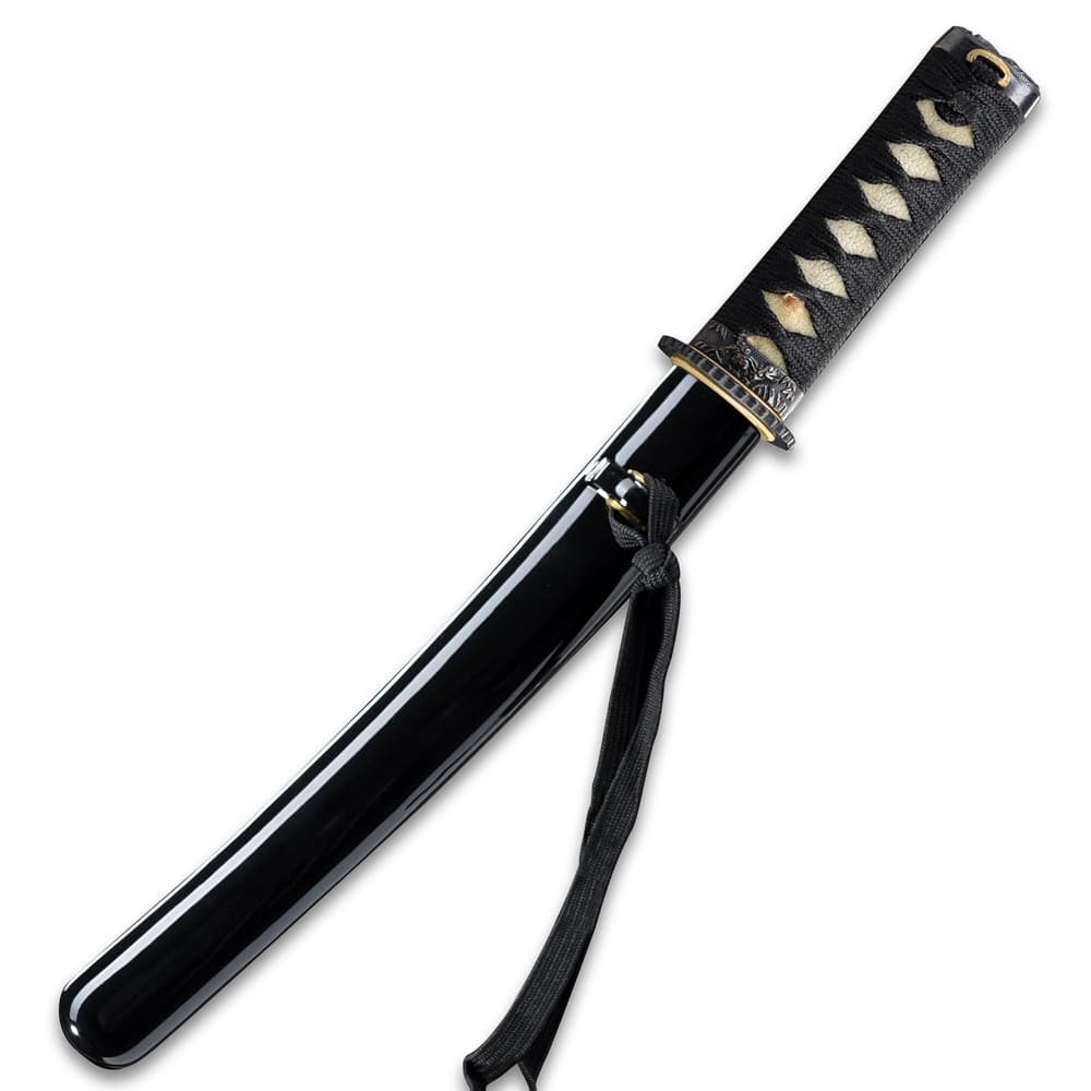 The 17” overall tanto sword fits like a glove in a black, lacquered wooden scabbard with black cord accents image number 1
