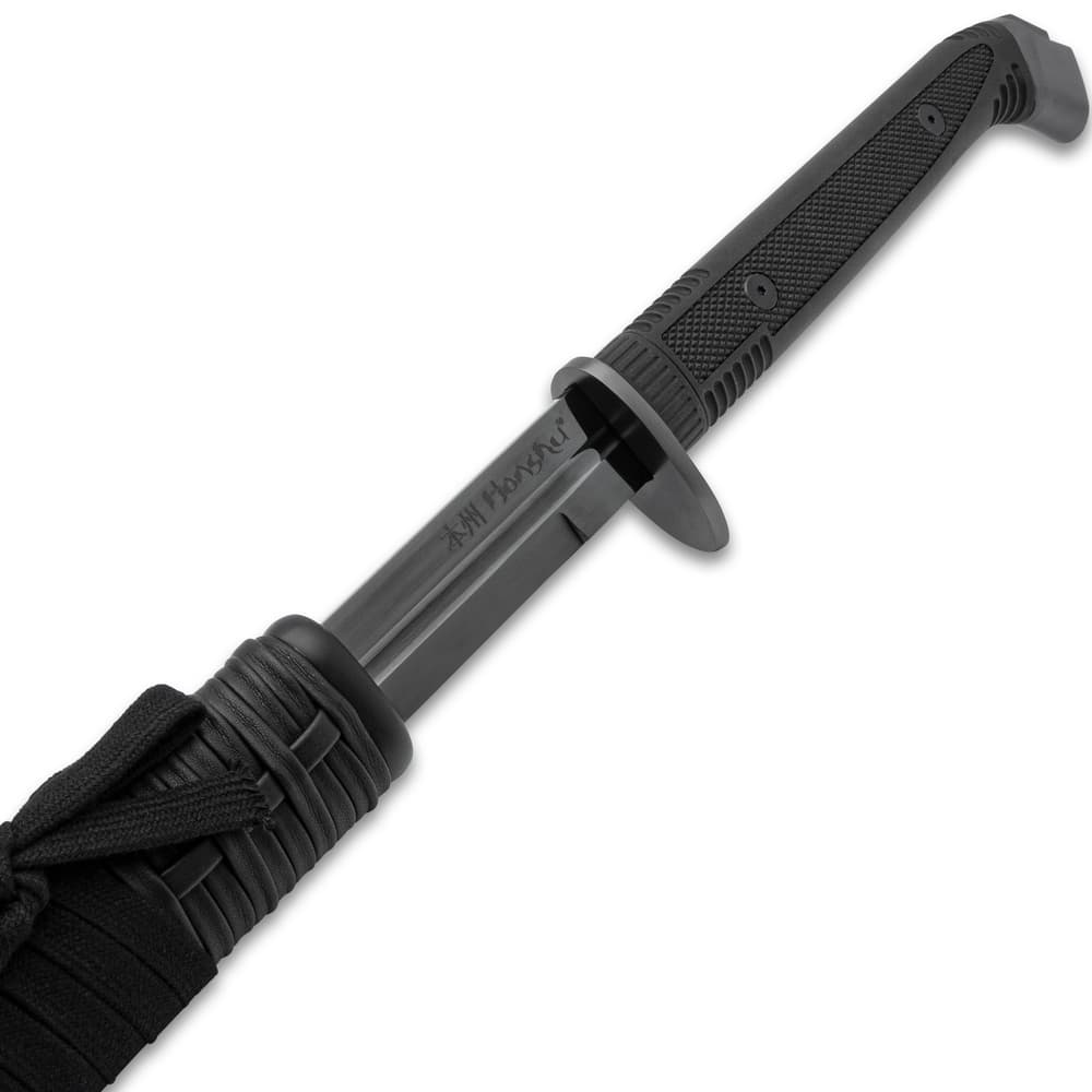 The double-edged sword slides smoothly into its black wooden sheath image number 1
