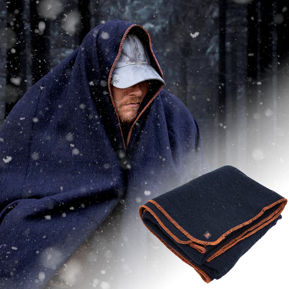 The wool blanket from the Survivalist bundle is shown both folded and wrapped around a man in snowy conditions. image number 2