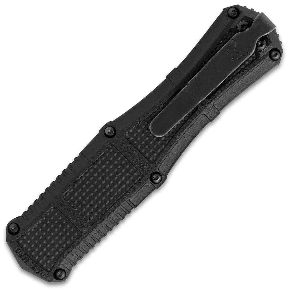 Angled image of the textured handle and deep carry clip on the Serrated OTF Knife. image number 2