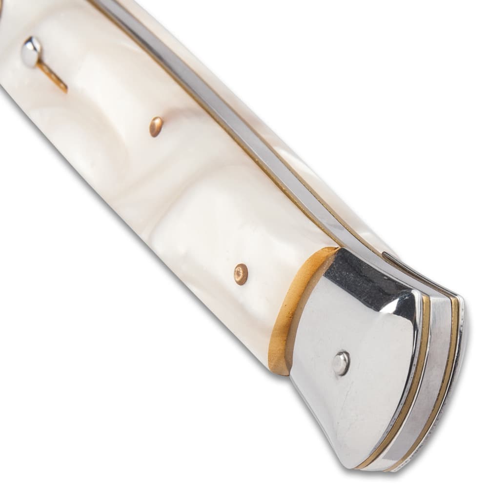 The 7 1/4” closed pocket knife has faux pearl handle scales, and the push button and slide lock are conveniently on top image number 2