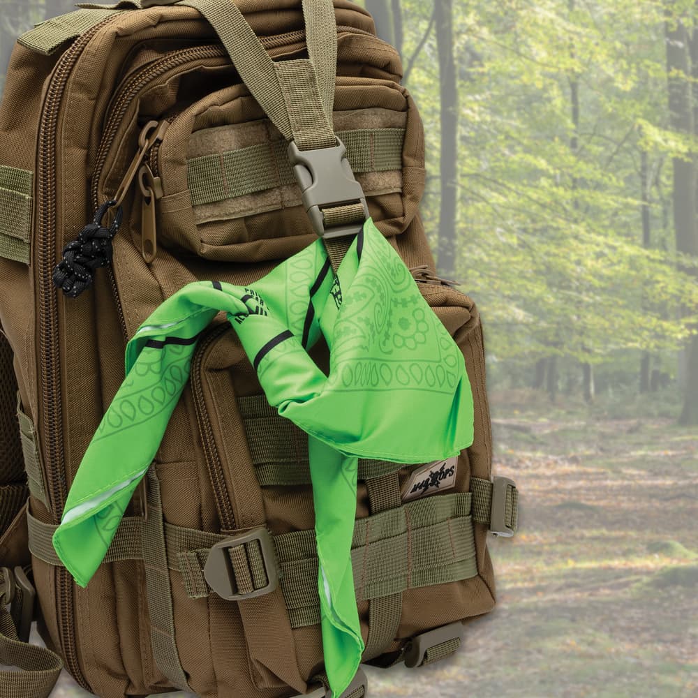 Full image of the Plant Guide Bandana tied onto a survival backpack. image number 2