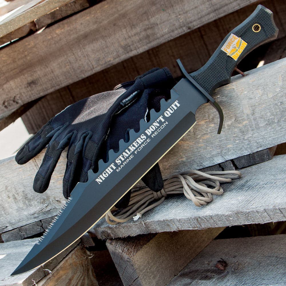 This knife has a double-serrated sawback stainless steel blade with black coating and textured black handle. image number 2
