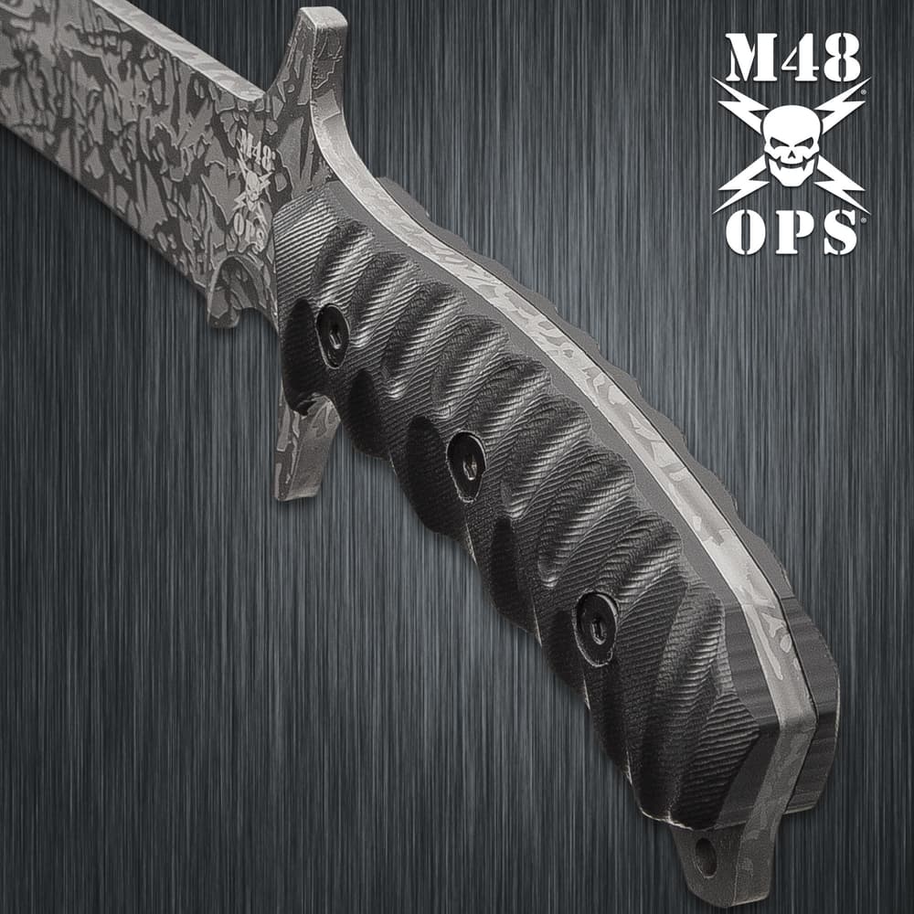 Upclose view of a black textured TPU handle secured to a machete tang with three black screws. image number 2