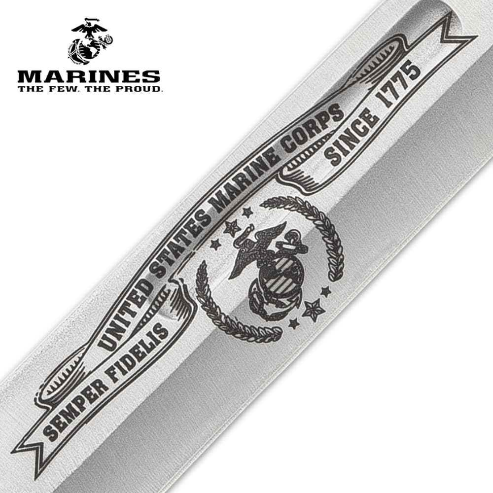 The knife has a keenly sharp, 6 3/4” stainless steel clip point blade with laser-etched Marines themed artwork image number 2