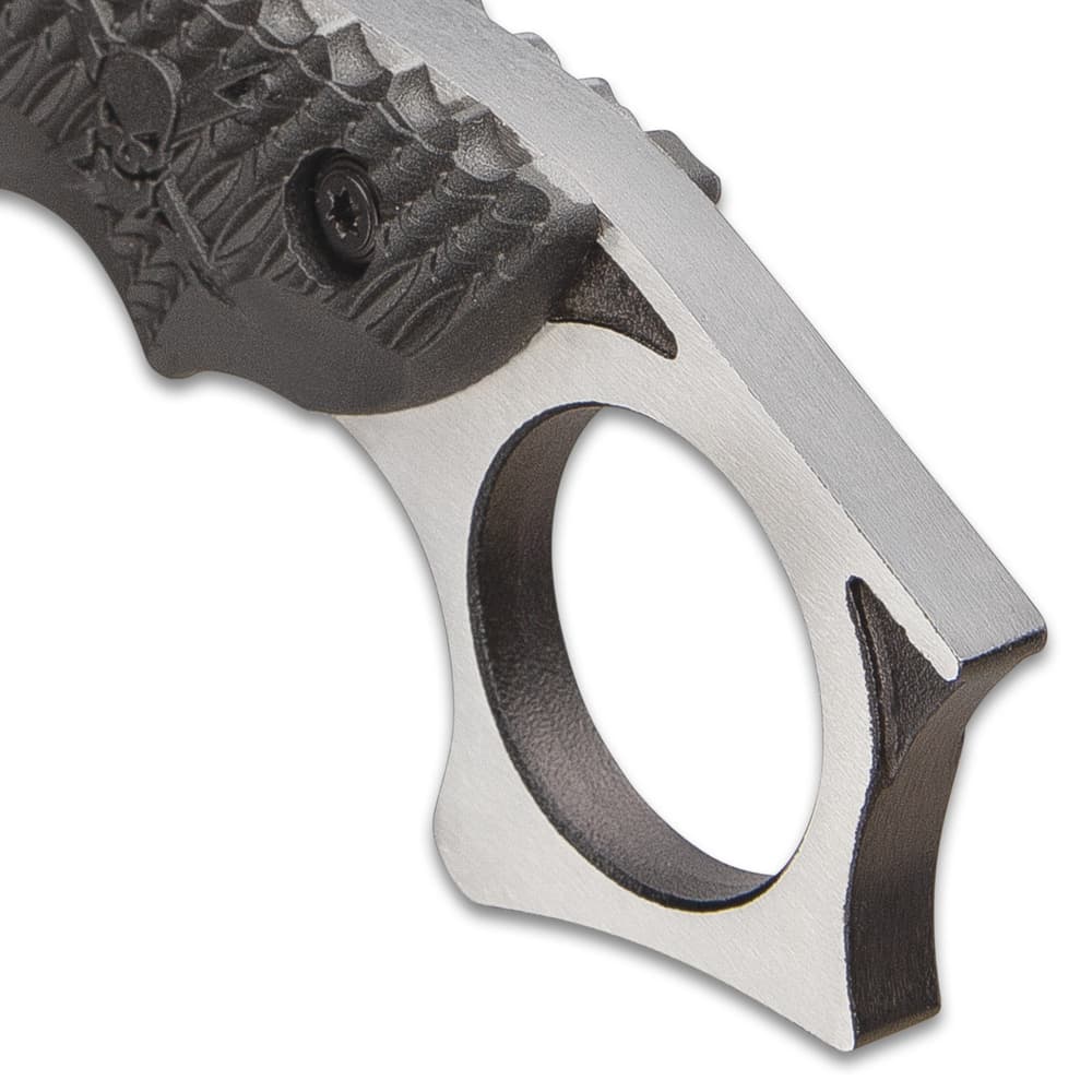 The full-tang blade has thumb notches and extends into a karambit-style open-ring pommel with fighting spurs image number 2
