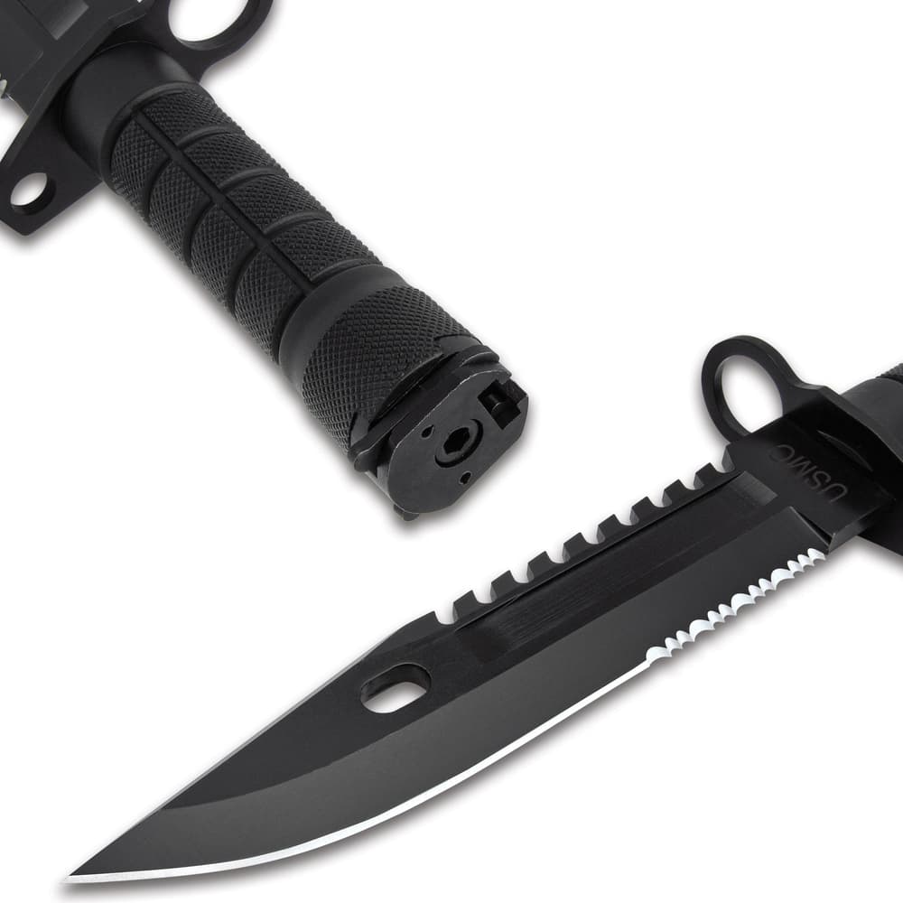 The knife has a 7” stainless steel blade with a sawback spine, extending from a muzzle-ring guard, and a laser-etched “USMC” image number 2