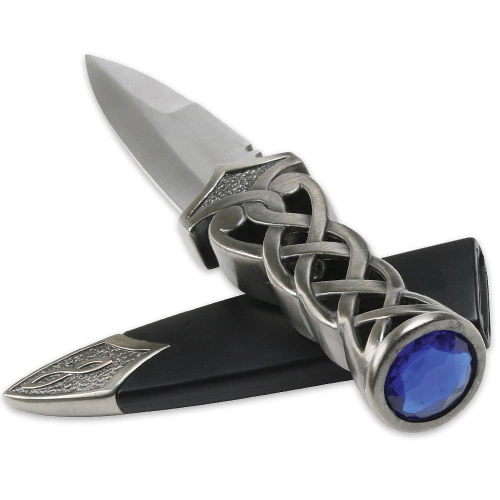 This knife has a faux blue jewel pommel on its twisted handle and comes with a black sheath with metal tip. image number 2