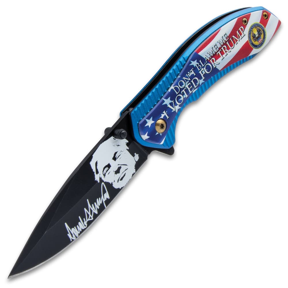 The knife has a black, stainless steel blade with white Trump themed artwork. image number 2