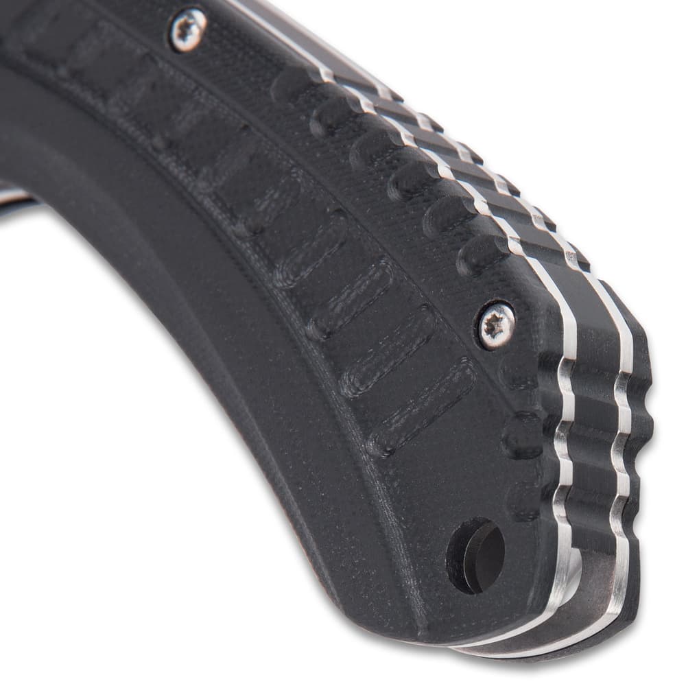 Detailed view of the end of the handle, made of black G10, with a lanyard hole. image number 2