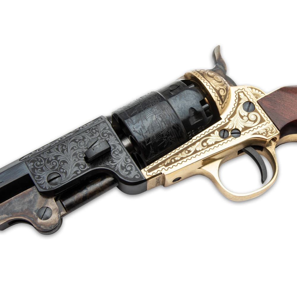 The .44 caliber, black powder pistol has an engraved solid brass frame with a 7 1/2” blued barrel and a wooden grip image number 2