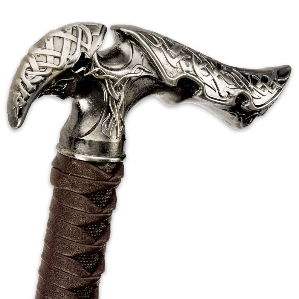 Zoomed view of Kit Rae Axios sword cane hilt embossed with designs and handle wrapped in faux leather image number 2