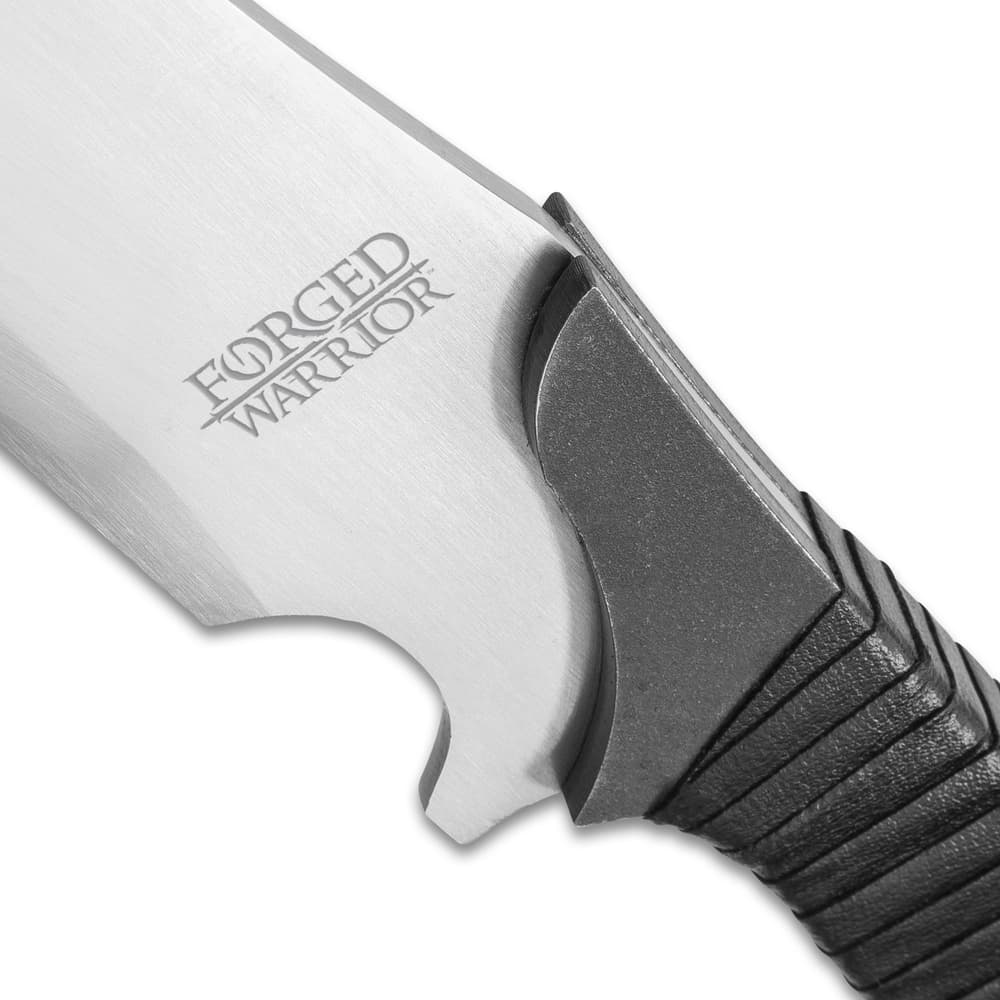 Zoomed view of high carbon steel with Forged Warrior engraved leading into the PU wrapped handle image number 2