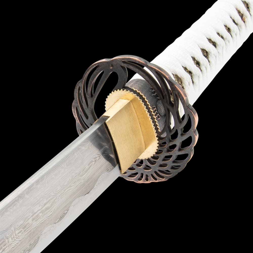 The handle is wrapped in gold-threaded cloth and white cord and has a cast metal pommel with a Samurai theme image number 2