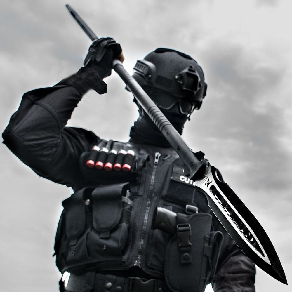 A personal in full black tactical gear is shown wielding the M48 Magnum Spear. image number 2