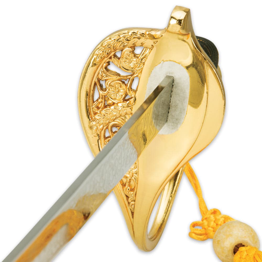 Zoomed view of the brass plated guard with floral design and heavy cord tassel on handle. image number 2