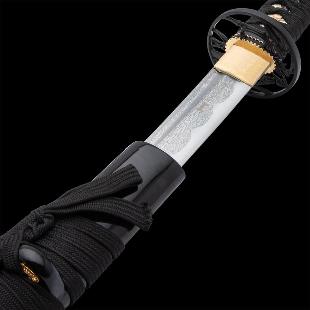 The high-quality katana has a 27 3/8”, keenly sharp Damascus steel blade, which extends from a brass habaki image number 2
