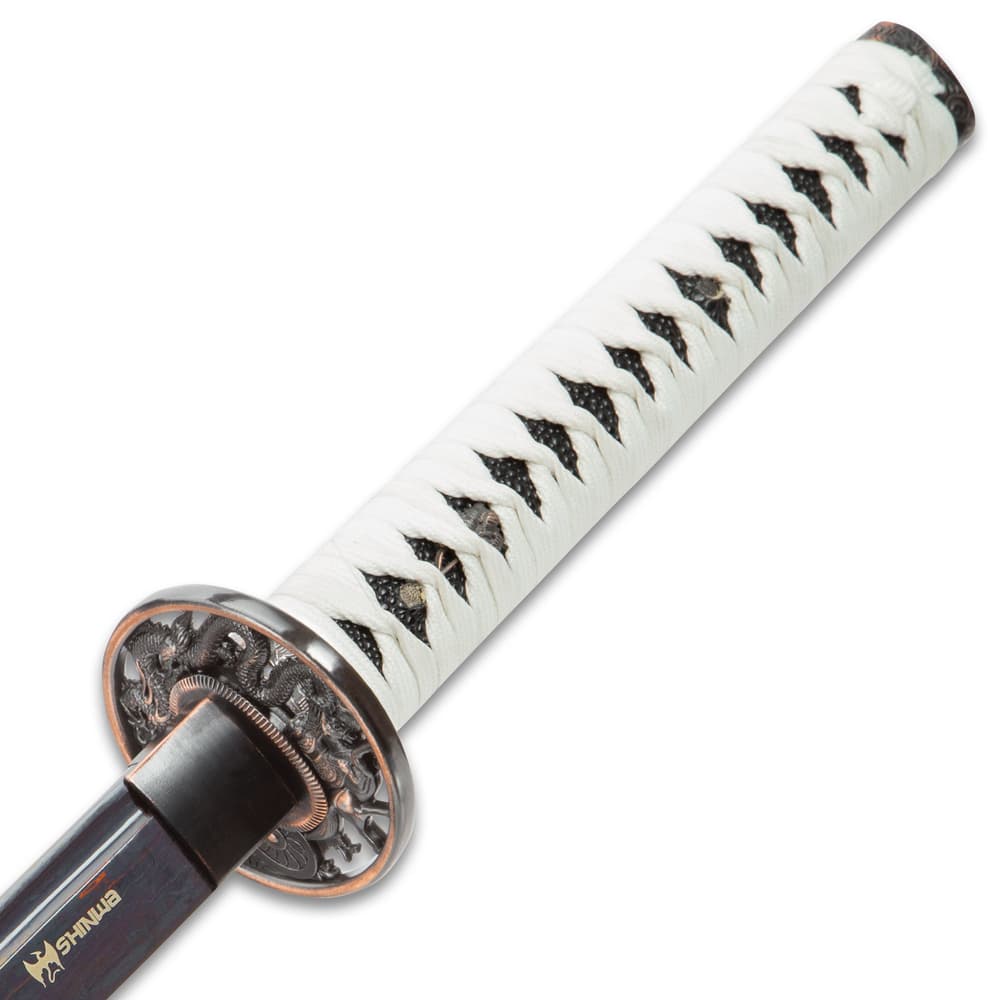 White braided cord wraps the faux rayskin handle of the sword with brass menuki. image number 2