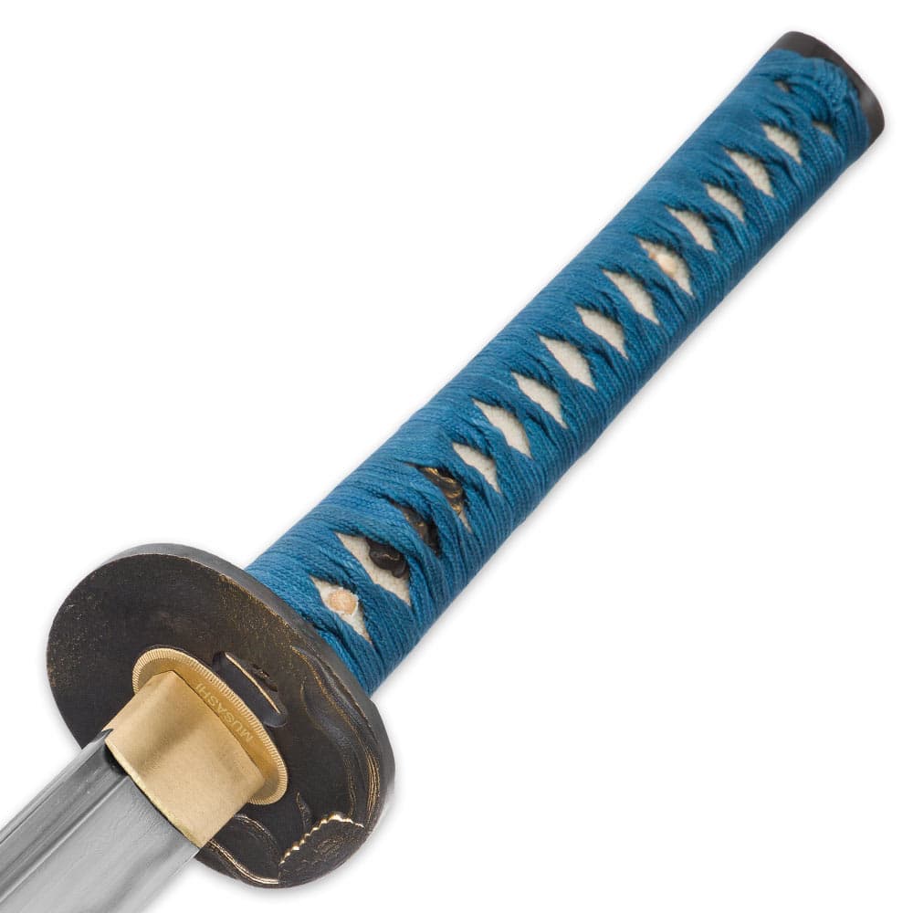 Close view of metal habaki attached to brass handguard leading to a tsuka wrapped with a bright teal cord image number 2