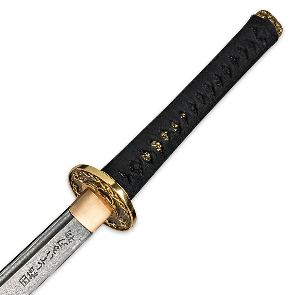 The genuine ray skin handle is wrapped in black cord with brass menuki above the ornate brass guard and etchings along blade. image number 2