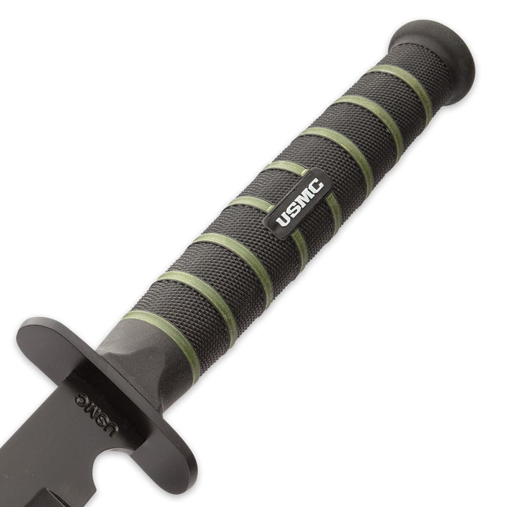 Zoomed view of the sword’s rubberized injection molded handle with textured grip that has “USMC” printed in the middle. image number 2